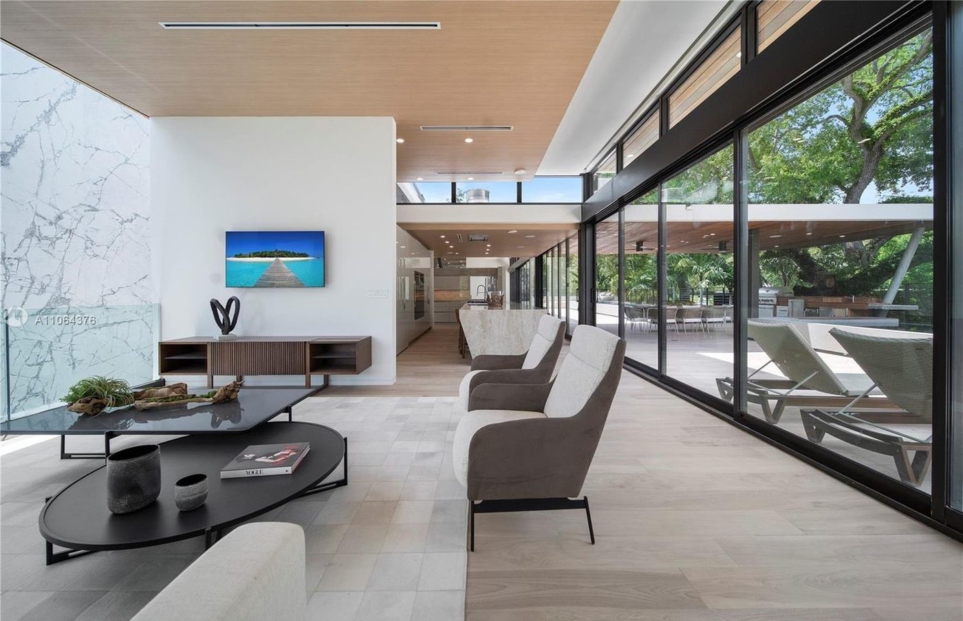 Living room opening to the terrace through full-height sliding glass doors