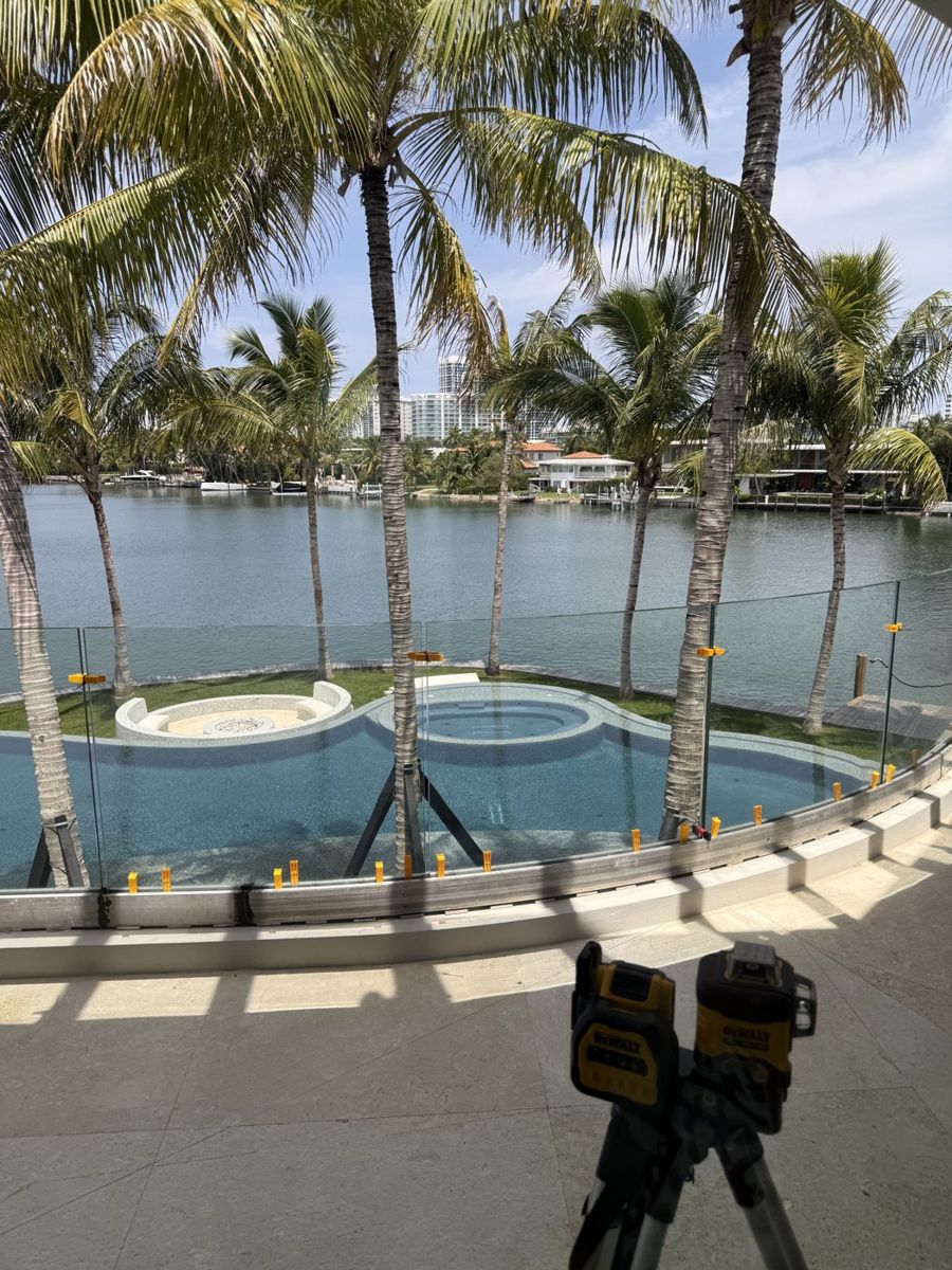 Laser line at a glass railing that overlooks the pool