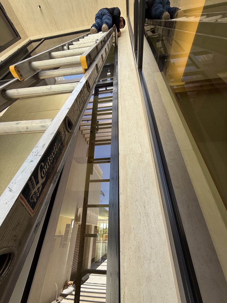 Window cleaning in progress on a double-height glass wall