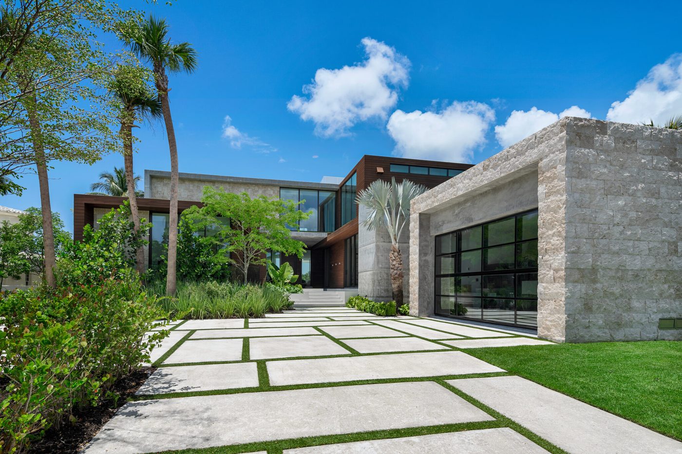 Street approach with oversized glass garage doors