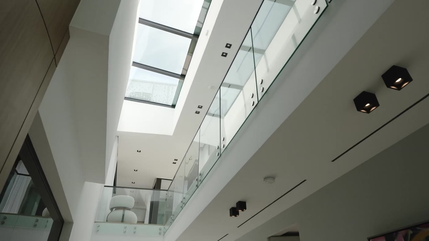 Skylight over a stair core with frameless glass railings, Hibiscus Island Spec Home III
