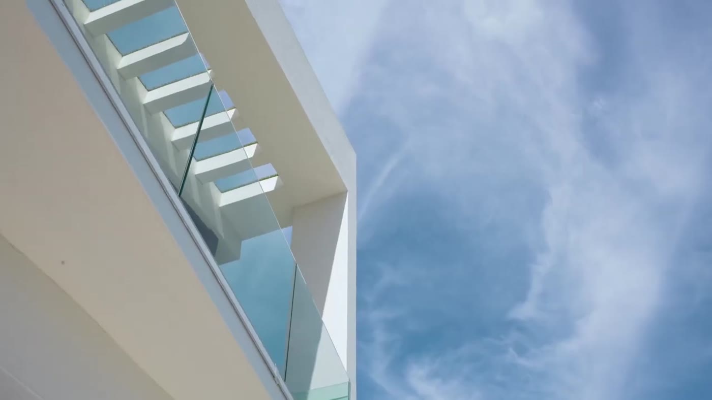 Looking up through a skylight over a glass-railed stair core, Hibiscus Island Spec Home III
