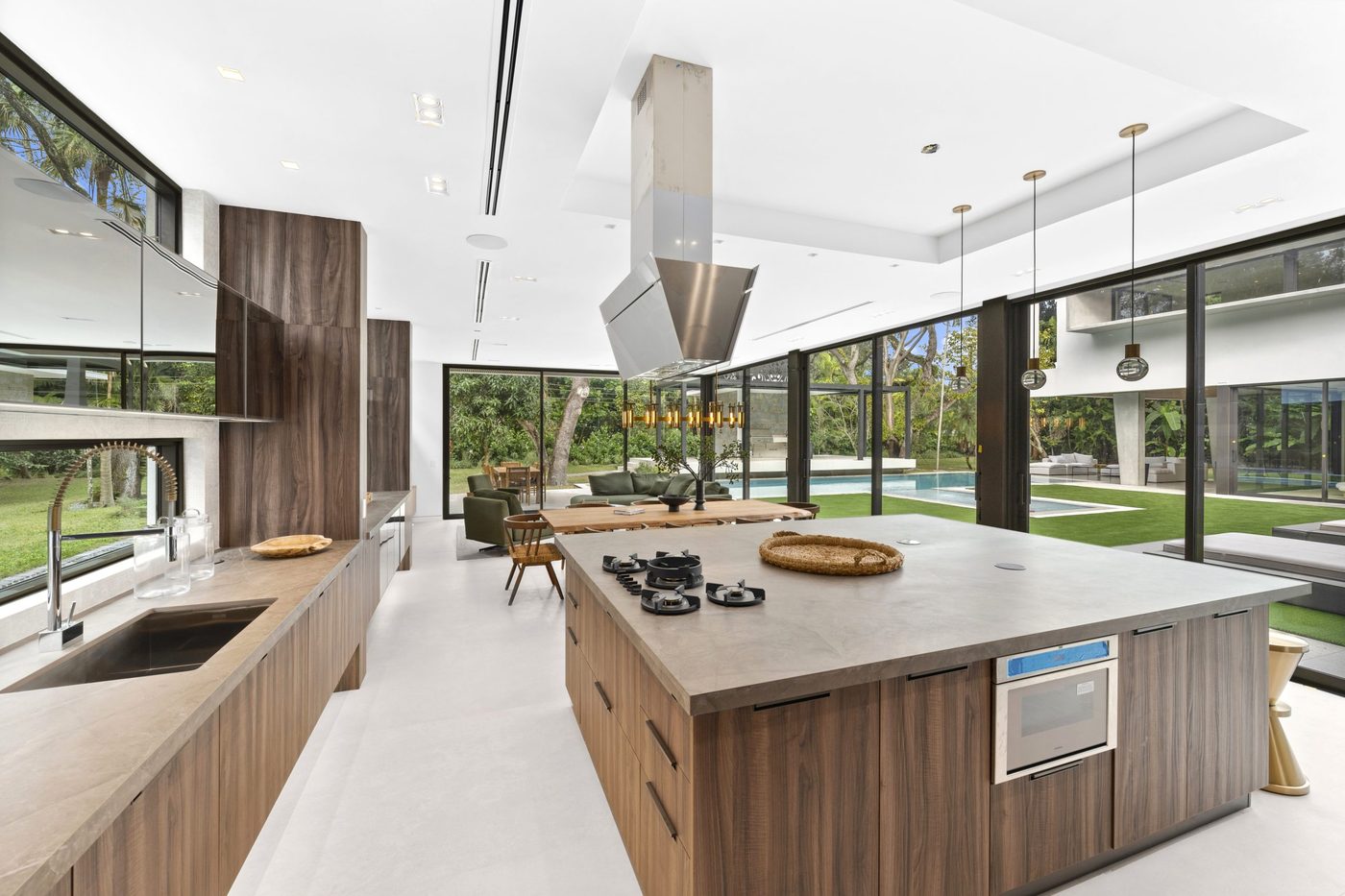 Kitchen lined with sliding glass doors to the pool terrace