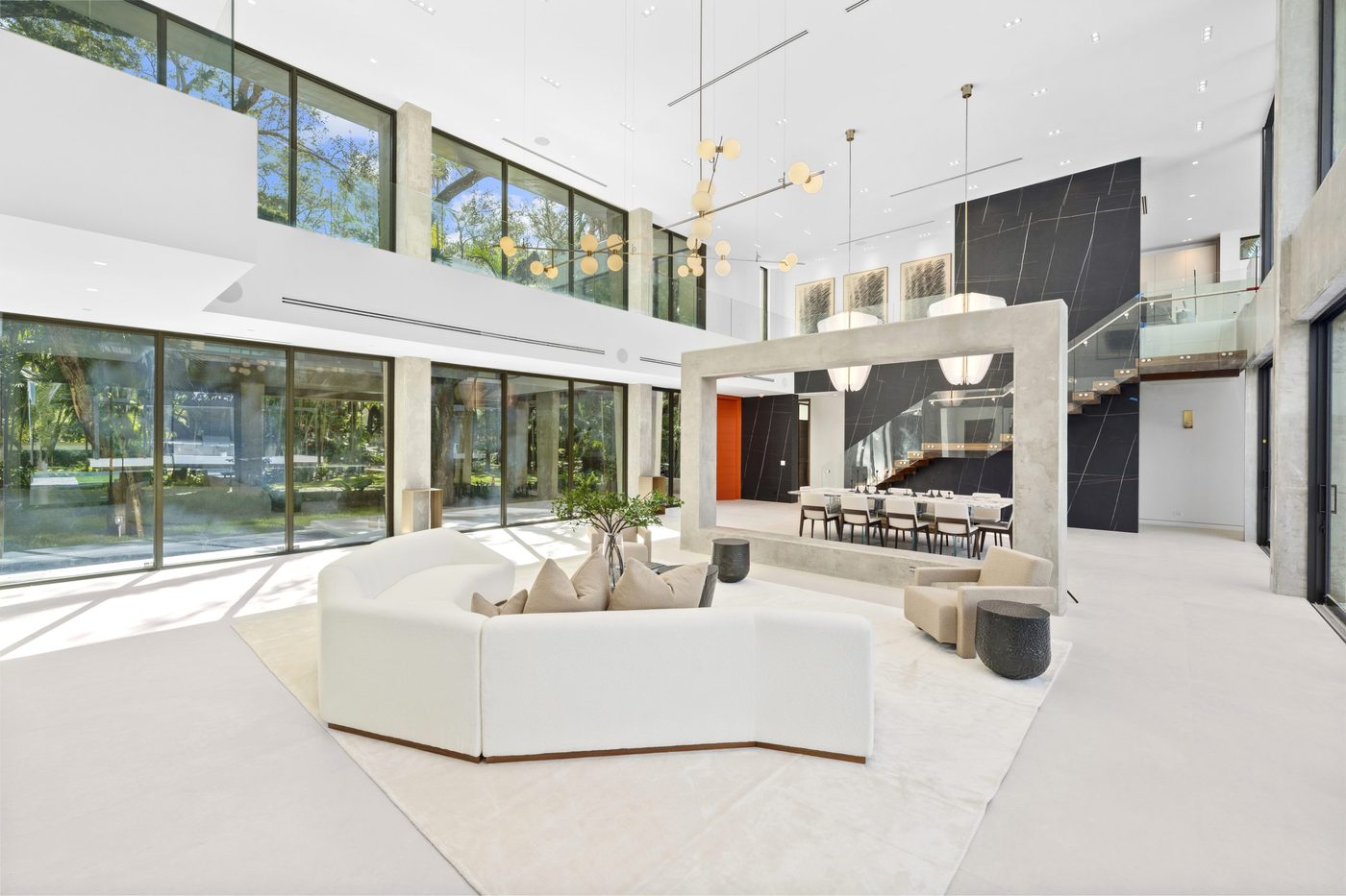 Great room with clerestory glazing, glass stair railing and mezzanine