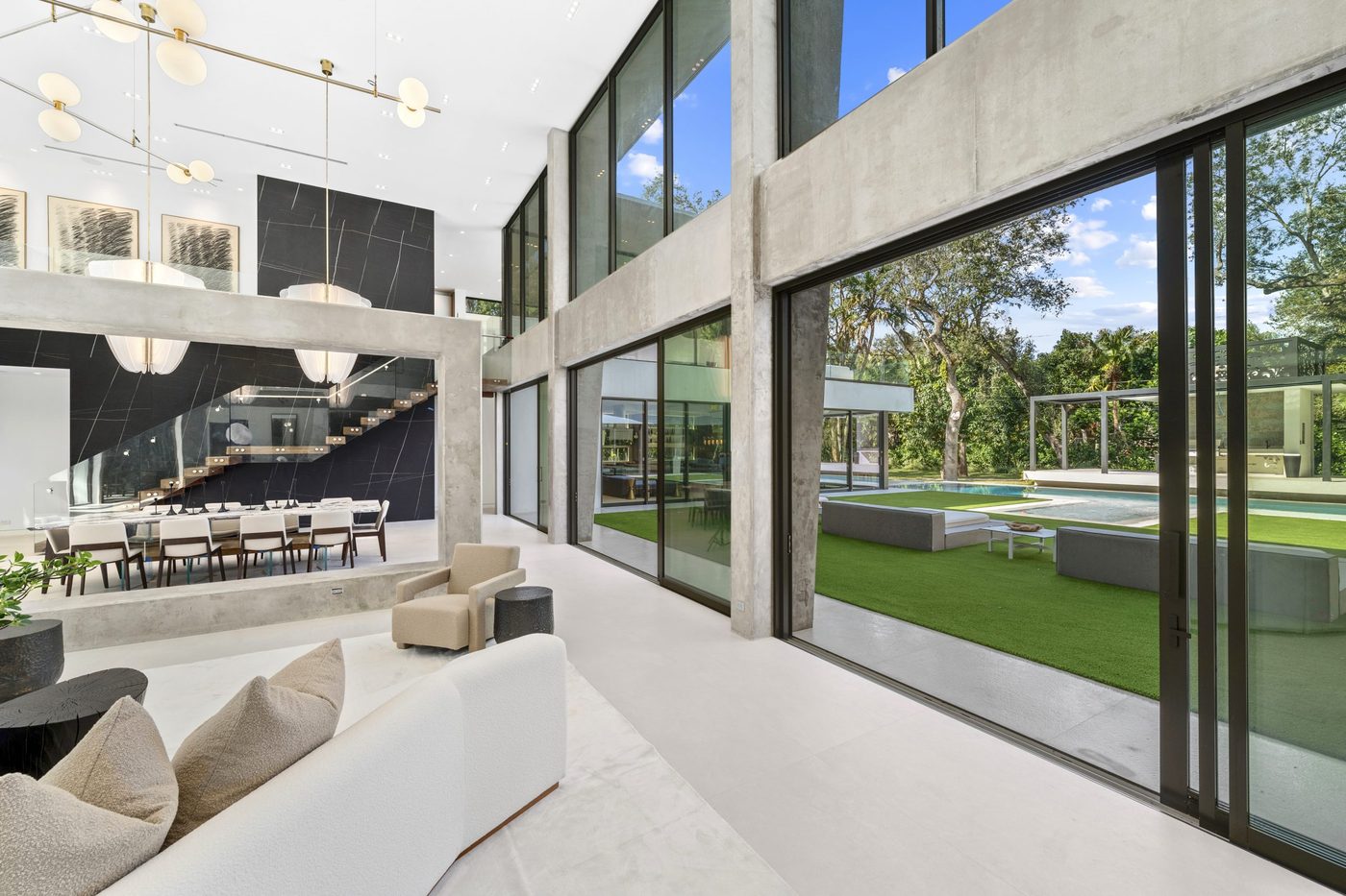 Oversized sliding doors open from the great room to the lawn and pool