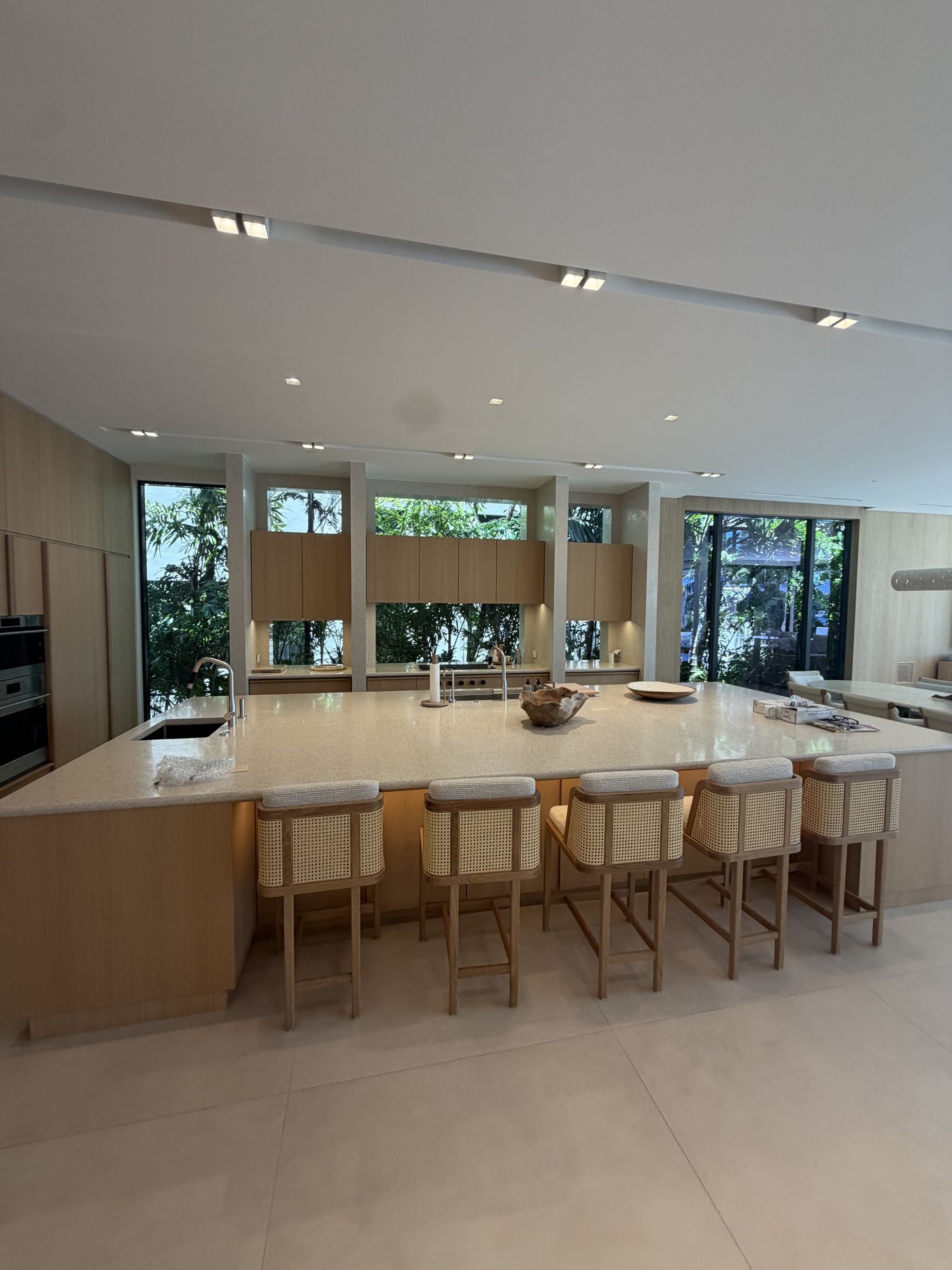 Kitchen with full-height windows and clerestory glazing looking into the garden