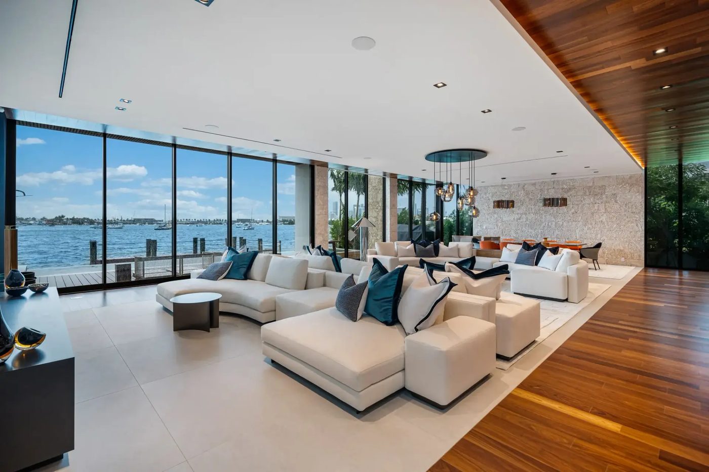 Living room walled in floor-to-ceiling glass facing Biscayne Bay