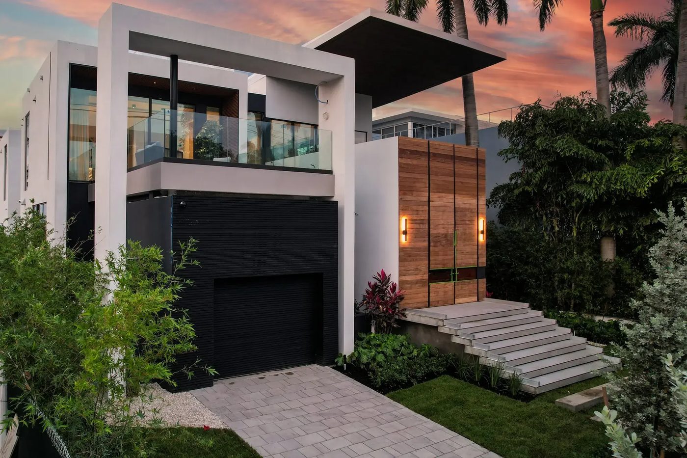 Front of the Venetian Way spec home at sunset with glass balcony railing